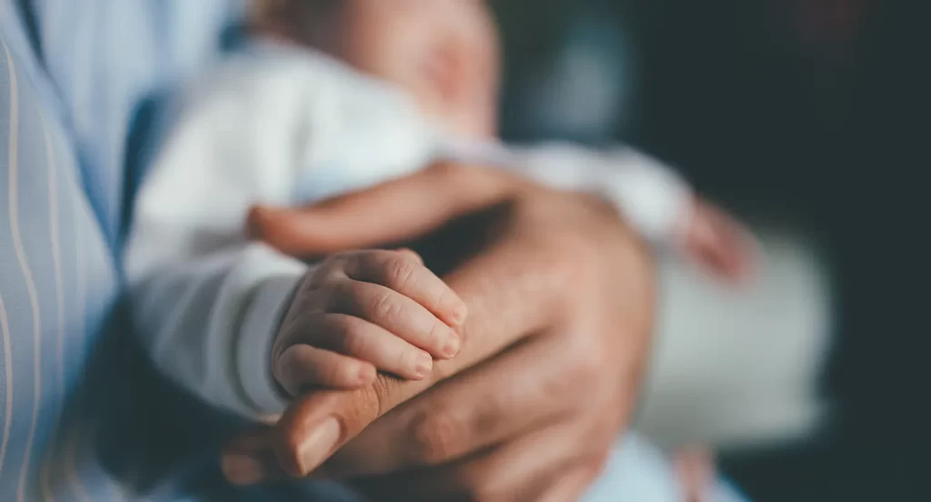 Baby in the hands of mother