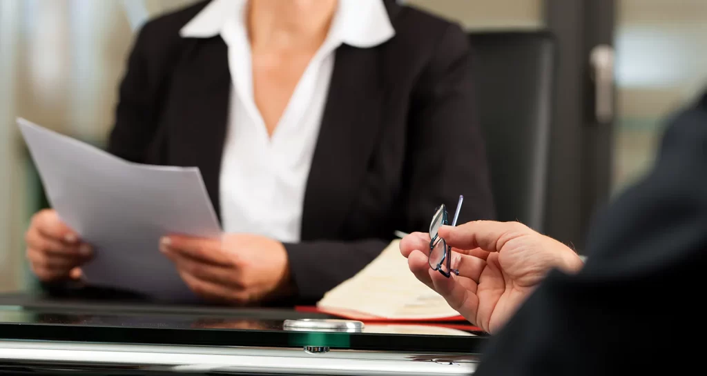 People reviewing paperwork around a table